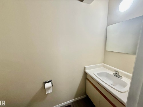 Bathroom vanity with integrated sink and single-handle chrome faucet - 10905 74 Avenue, Edmonton, AB - Indoor Photo Showing Bathroom