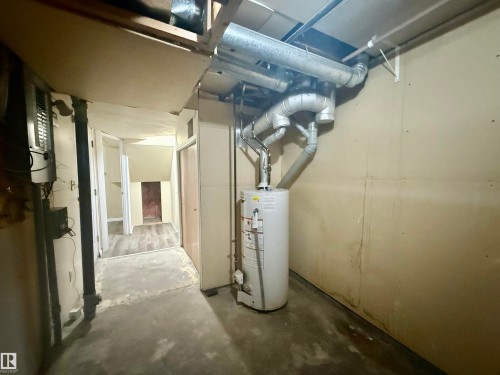 Utility area featuring a water heater, exposed ductwork, and concrete flooring - 10905 74 Avenue, Edmonton, AB - Indoor