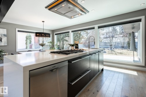 Kitchen island with integrated gas cooktop and stainless steel dishwasher - 4204 Aspen Drive E, Edmonton, AB - Indoor Photo Showing Kitchen