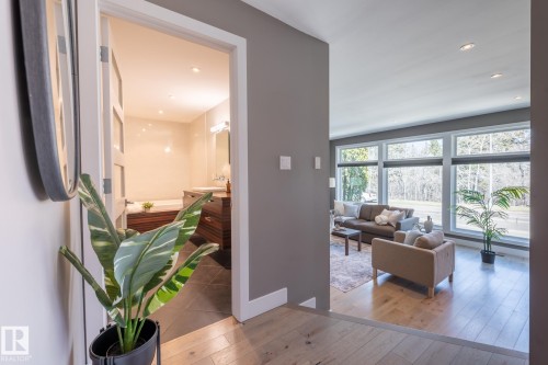Open concept living space with wood-finish flooring and expansive windows - 4204 Aspen Drive E, Edmonton, AB - Indoor