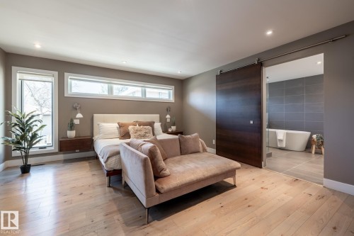 Spacious room featuring light wood-finish flooring, recessed lighting, and large windows - 4204 Aspen Drive E, Edmonton, AB - Indoor Photo Showing Bedroom