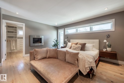 Recessed lighting illuminates wood-finish flooring and neutral wall tones - 4204 Aspen Drive E, Edmonton, AB - Indoor Photo Showing Bedroom