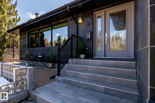 Entry features a gray paneled door with decorative glass inserts and a sidelight - 4204 Aspen Drive E, Edmonton, AB - Outdoor With Deck Patio Veranda With Exterior