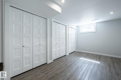 Room featuring wood-finish flooring, recessed lighting, and a window with white trim - 4204 Aspen Drive E, Edmonton, AB - Indoor Photo Showing Other Room