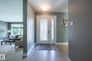 Entryway featuring light wood-finish flooring and a decorative double door with frosted glass panels - 4204 Aspen Drive E, Edmonton, AB  - Indoor Photo Showing Other Room 
