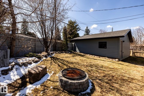 Spacious backyard with a detached garage featuring horizontal siding and an asphalt shingle roof - 4204 Aspen Drive E, Edmonton, AB - Outdoor