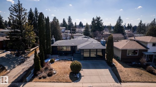 Contemporary exterior with dark siding and a grey shingle roof - 4204 Aspen Drive E, Edmonton, AB - Outdoor