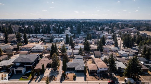 Residential area featuring a variety of housing styles, mature trees, and paved roads - 4204 Aspen Drive E, Edmonton, AB - Outdoor With View