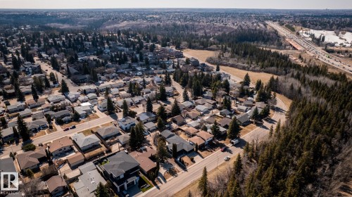 Aerial perspective of a residential area with a prominent tree-lined perimeter - 4204 Aspen Drive E, Edmonton, AB - Outdoor With View