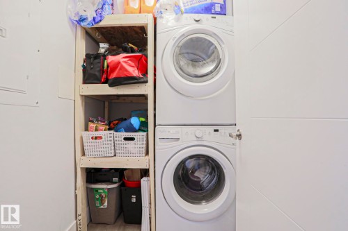 Stacked washer and dryer units for efficient use of space - 202 10030 83 Avenue, Edmonton, AB - Indoor Photo Showing Laundry Room