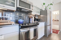 Modern kitchen with stainless steel appliances, including an electric range and microwave - 