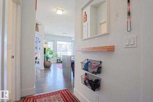 Hardwood-style flooring throughout, with a recessed ceiling light fixture and modern white trim - 202 10030 83 Avenue, Edmonton, AB - Indoor Photo Showing Other Room