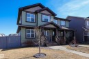 Two-story residence featuring light green siding and dark trim accents - 3805 170A Avenue, Edmonton, AB  - Outdoor With Facade 