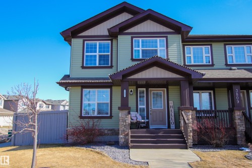 Two-story residence featuring light green siding and dark trim accents - 3805 170A Avenue, Edmonton, AB - Outdoor With Deck Patio Veranda With Facade