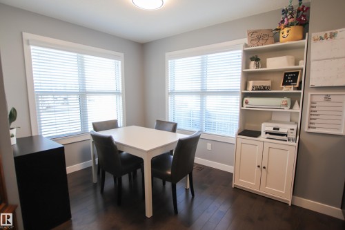 Interior space featuring dark wood-finish flooring and light gray painted walls - 3805 170A Avenue, Edmonton, AB - Indoor Photo Showing Dining Room
