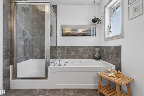 Bathroom featuring a combination tub and shower with glass enclosure - 2313 Sparrow Crescent, Edmonton, AB - Indoor Photo Showing Bathroom
