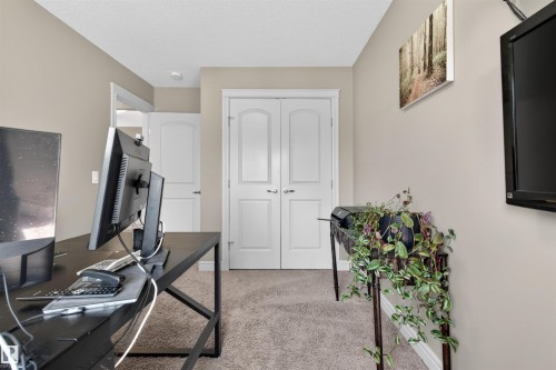 Beige wall paint, textured carpet flooring, and white trim throughout - 2313 Sparrow Crescent, Edmonton, AB - Indoor