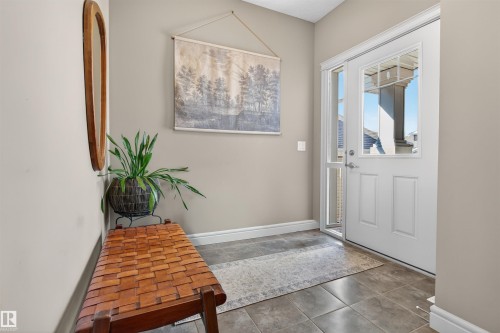 Entryway featuring a white paneled door with windowpanes, a full-length sidelight, and neutral wall paint - 2313 Sparrow Crescent, Edmonton, AB - Indoor Photo Showing Other Room
