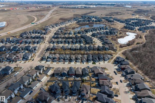 Expansive aerial perspective showcasing a residential development with multiple streets and numerous single-family homes - 2313 Sparrow Crescent, Edmonton, AB - Outdoor With View