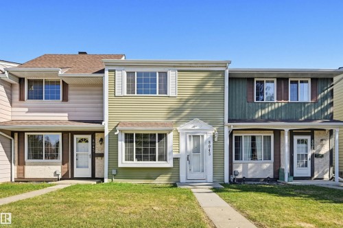 Townhome exterior featuring light green horizontal siding and white window trim - 8043 178 Street, Edmonton, AB - Outdoor With Facade