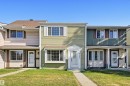 Townhome exterior featuring light green horizontal siding and white window trim - 8043 178 Street, Edmonton, AB  - Outdoor With Facade 