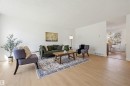 Light wood-finish flooring extends through this open living space - 8043 178 Street, Edmonton, AB  - Indoor Photo Showing Living Room 