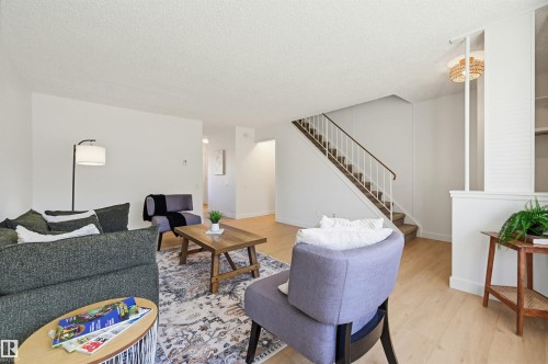 Living area with light wood-finish flooring and white walls - 8043 178 Street, Edmonton, AB - Indoor Photo Showing Living Room