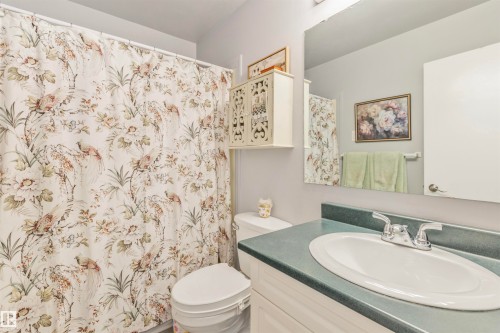 Bathroom featuring a white vanity with a green countertop and an integrated sink - 1619 Knottwood Road N, Edmonton, AB - Indoor Photo Showing Bathroom