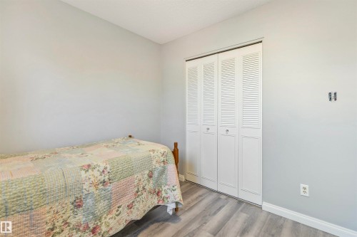 Room featuring light gray walls, wood-finish flooring, and white baseboards - 1619 Knottwood Road N, Edmonton, AB - Indoor Photo Showing Bedroom