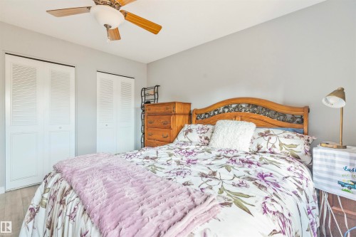 Bedroom with light gray walls, wood-finish flooring, and a ceiling fan with light fixture - 1619 Knottwood Road N, Edmonton, AB - Indoor Photo Showing Bedroom