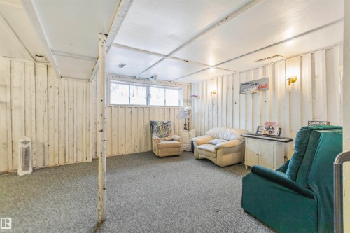 Finished lower level with paneled walls, recessed lighting, and carpeted flooring - 1619 Knottwood Road N, Edmonton, AB - Indoor