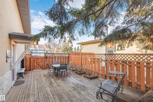 Expansive outdoor wood deck with a full wood privacy fence and lattice accent - 1619 Knottwood Road N, Edmonton, AB - Outdoor With Deck Patio Veranda With Exterior