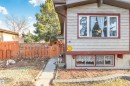 Split-level exterior featuring light-colored horizontal siding and contrasting red trim - 1619 Knottwood Road N, Edmonton, AB  - Outdoor 