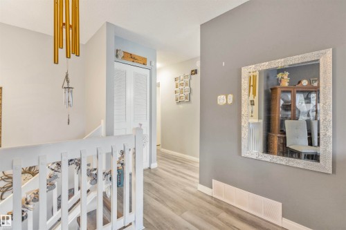 Hallway featuring light wood-finish flooring and a white railing - 1619 Knottwood Road N, Edmonton, AB - Indoor Photo Showing Other Room