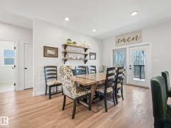 Bright dining area featuring wood-finish flooring, recessed lighting, and white walls - 