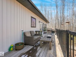 Expansive wood-finish deck with black metal railing - 