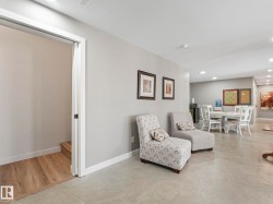 Spacious interior showcasing light gray walls, recessed lighting, and durable concrete-finish flooring - 