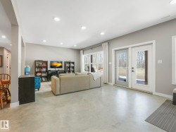 Spacious room featuring light gray walls, recessed lighting, and a durable concrete floor - 