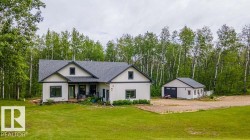 Modern farmhouse-style home with a dark shingle roof and light-colored siding - 