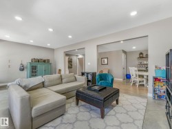 Open-concept living space featuring recessed lighting, light gray wall tones, and polished concrete flooring - 