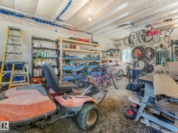 Enclosed garage space featuring exposed ceiling joists with white insulation - 