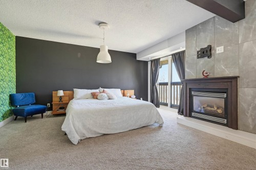 139 Wolf Willow Crescent, Edmonton, AB - Indoor Photo Showing Bedroom With Fireplace