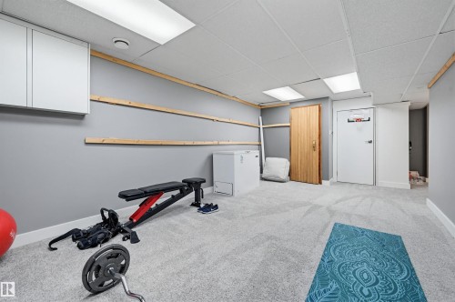 Spacious room featuring light gray carpeting, recessed lighting, and a drop ceiling - 139 Wolf Willow Crescent, Edmonton, AB - Indoor