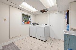Dedicated utility space featuring patterned floor tile, recessed shelving with decorative backing, and a built-in wash basin - 