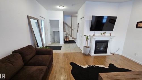 Looking towards the basement stairs and front entrance - 58513 Range Road 231, Rural Thorhild County, AB - Indoor Photo Showing Living Room With Fireplace