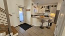 Kitchen featuring stainless steel appliances, tasteful backsplash, pendant lighting, a breakfast bar, and a peninsula - 58513 Range Road 231, Rural Thorhild County, AB  - Indoor Photo Showing Kitchen With Double Sink 