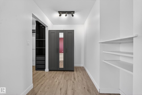 Hallway featuring wood-finish flooring, recessed lighting, and built-in shelving - 1767 61 Street, Edmonton, AB - Indoor Photo Showing Other Room