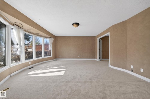 Expansive room with neutral carpeting and textured walls - 1767 61 Street, Edmonton, AB - Indoor Photo Showing Other Room