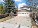 Two-story residence featuring a two-car garage with panel windows, a concrete driveway, and brick accents - 1767 61 Street, Edmonton, AB  - Outdoor 