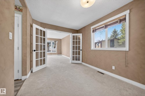 Spacious room with light-toned carpeting and neutral wall tones - 1767 61 Street, Edmonton, AB - Indoor Photo Showing Other Room